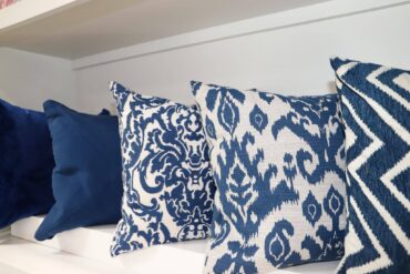 blue patterned pillows on shelf