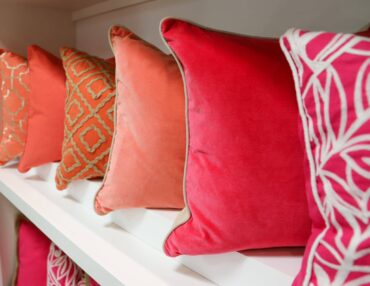 Pink pillows on white shelf