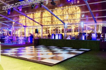 Boxwood Stage Facade with Checkerboard Dance Floor at The Joule Lawn