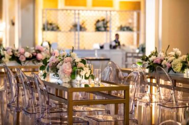 Gold and Mirrored Communal Table with Ghost Barstools Charlotte Banquettes, Oxford Sofas, Stella Stools, and Lindsey Coffee Tables at a River Oaks Country Club Wedding