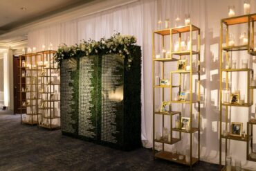 Boxwood Walls with Acrylic Sign with Gold Shelves at Ritz Carlton Wedding planned by Mathes & Co. | Escort Card Display