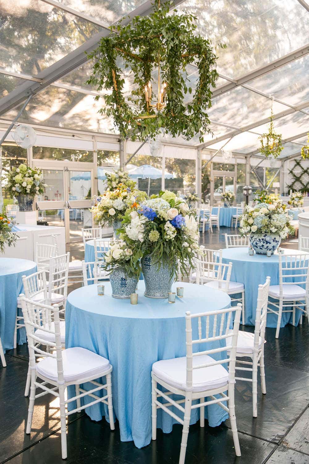White chairs set with table with blue tablecloth
