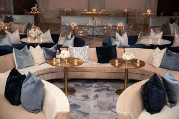 Gold Bistro Table with Extended Charlotte Banquette and Perch Pillows | Jordan Kahn Music Company Showcase | Jordan Kahn Orchestra Showcase at The Ritz Carlton Dallas