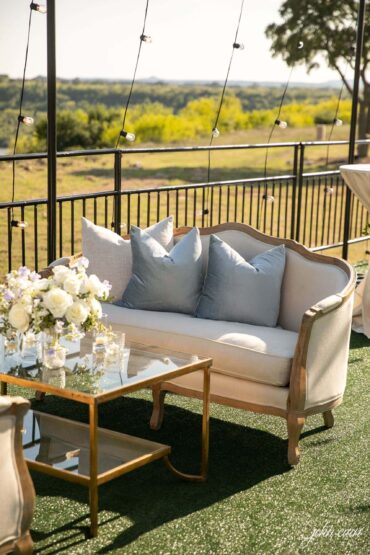 Diana Loveseat with Gold and Glass Coffee Table, BLUE 002, and IVORY 008 at Possum Kingdom Lake | Branching Out Floral and Event Design | Haylie Paige Events