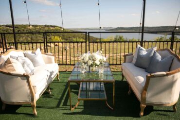 Gold and Glass Coffee Table with Diana Loveseats at Possum Kingdom Lake | Branching Out Events