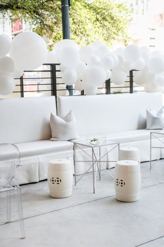 Tayler Banquettes with Silver Star Accent Tables, Ghost Arm Chairs, and White Garden Stools at The Ripley Building | Brock & Co. Events