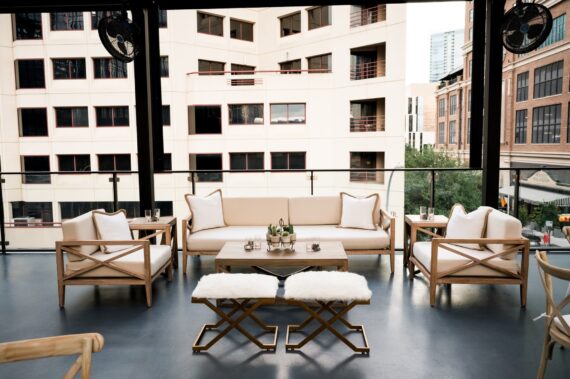 Miller Sofa with Miller Chairs, WHITE 006 Pillows, Faux Fur Side Benches, Carson Coffee Table, and Carson Side Tables at The Ripley Building | Brock & Co. Events
