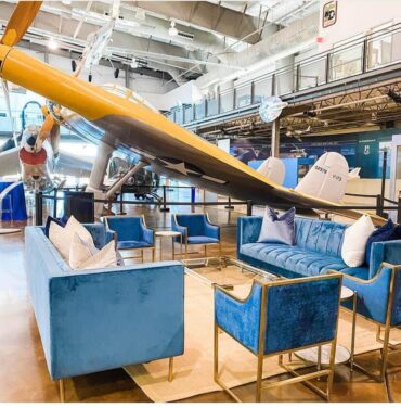 Belmont Sofa with Acrylic and Gold Coffee Table, Navy Dakota Chairs, and Marble Accent Tables at Frontier of Flight Museum | Brigade Events