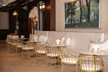 Tayler Banquettes with Marble and Gold Bistro Tables and Brass Bamboo Arm Chairs at Dallas Country Club | Weddings a la Carte | Garden Gate Floral