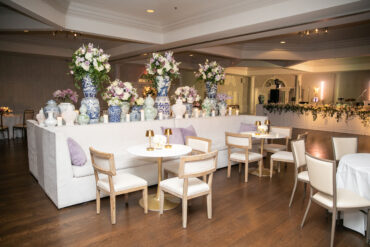 Lane Banquettes with White and Gold Bistro Tables, Charles Dining Chairs, and Gold Martini Lamps at Northwood Country Club | Park Cities Events | Garden Gate Floral