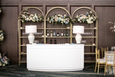 Newport Bar with Pearl Lamps and Gold Curved Shelves at Dallas Petroleum Club | GRO Designs