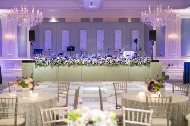 Annie Stage Facade with 10'H Estelle Backline with custom vinyls at Dallas Country Club | Bella Festa Event Planning