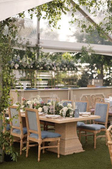 Natural Wood Delaney Dining Table with Natural Wood Arthur Dining Chairs with Dusty Blue Velvet Cushions at Alex Camp House at the Dallas Arboretum | Pop Parties